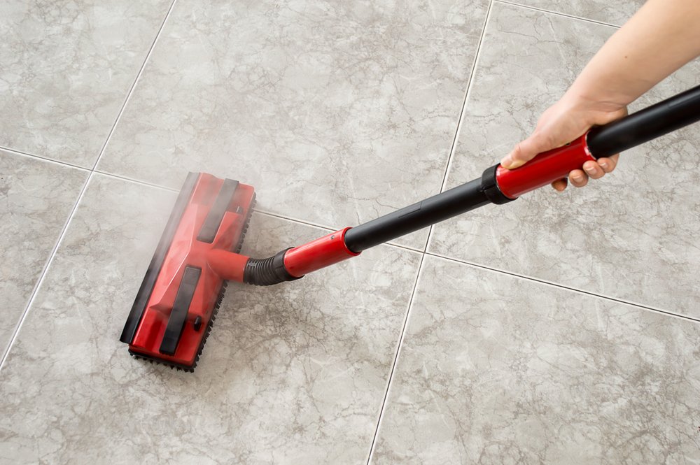 Woman Cleaning Tile Floor with a swiffer